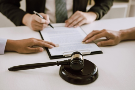 couple handing over wedding rings at lawyer's office