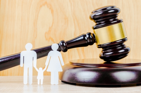 paper cutout of family and gavel