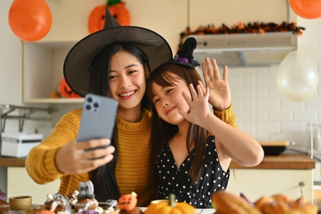 mother and daughter on a video call during Halloween