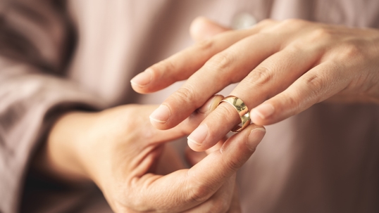 person removing wedding ring