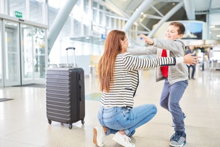 mother and son hugging at the airport